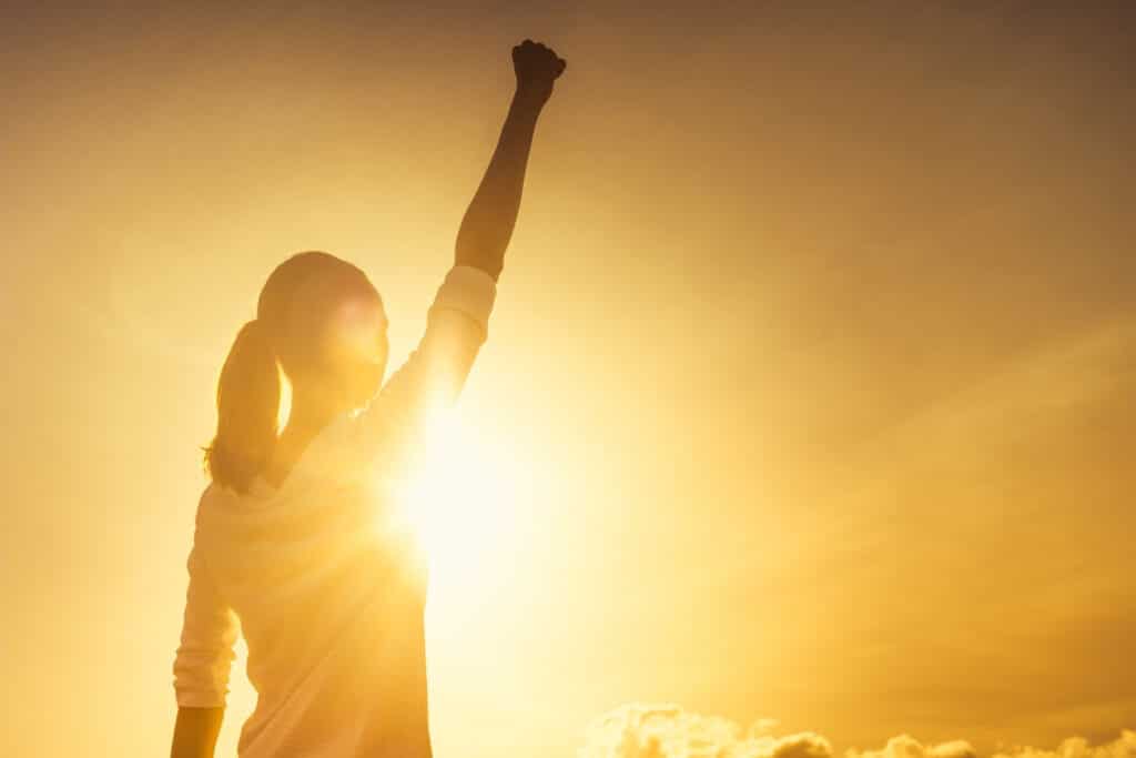 woman raising hand in victory over an offense